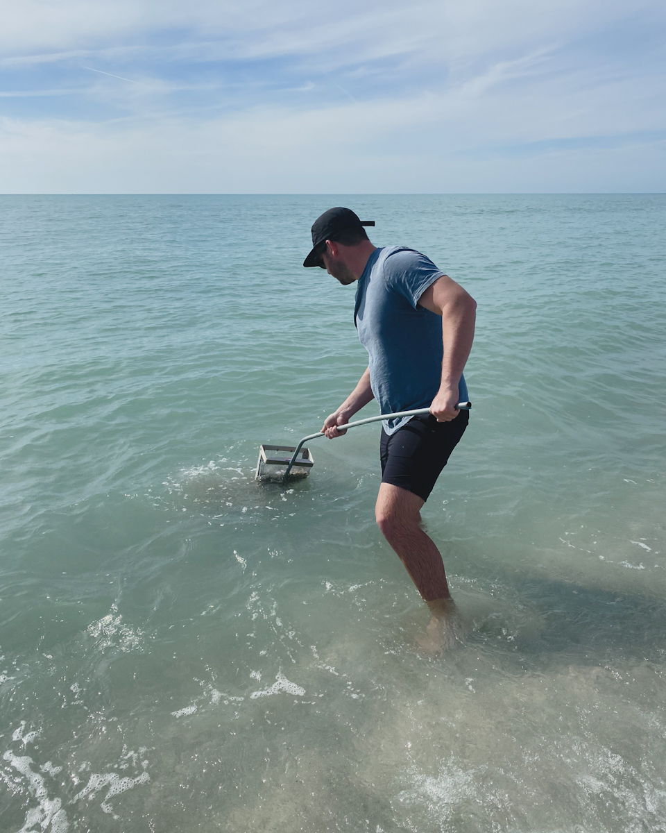 Using a sand sieve to find shark teeth in Venice Florida
